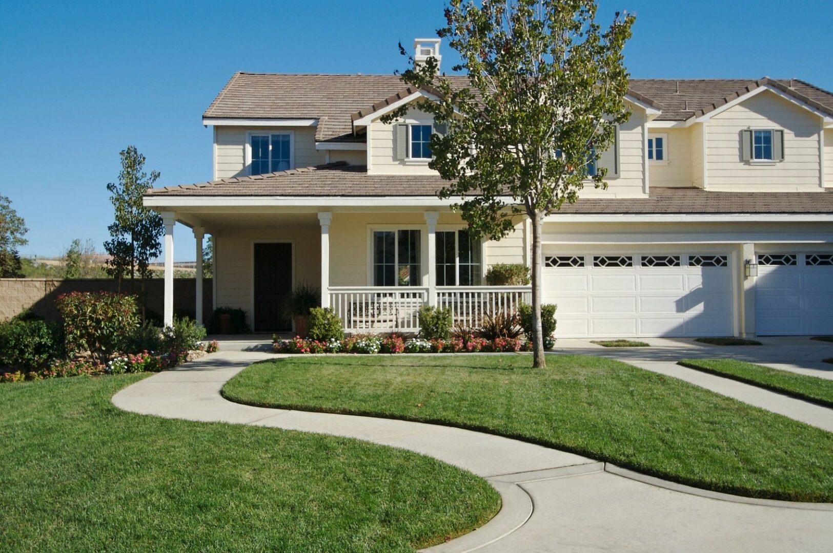 A newly constructed, modern american home with fresh landscaping