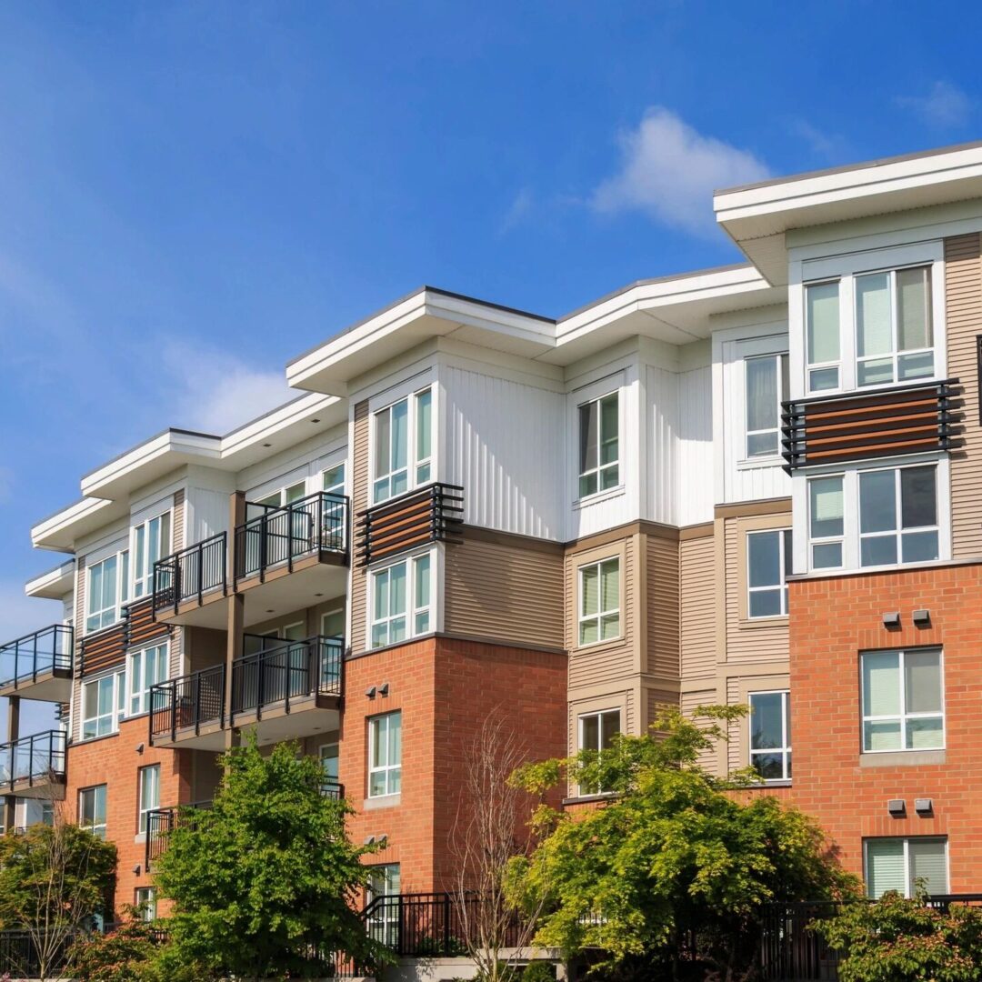 Modern apartment building in sunny day against blue sky.