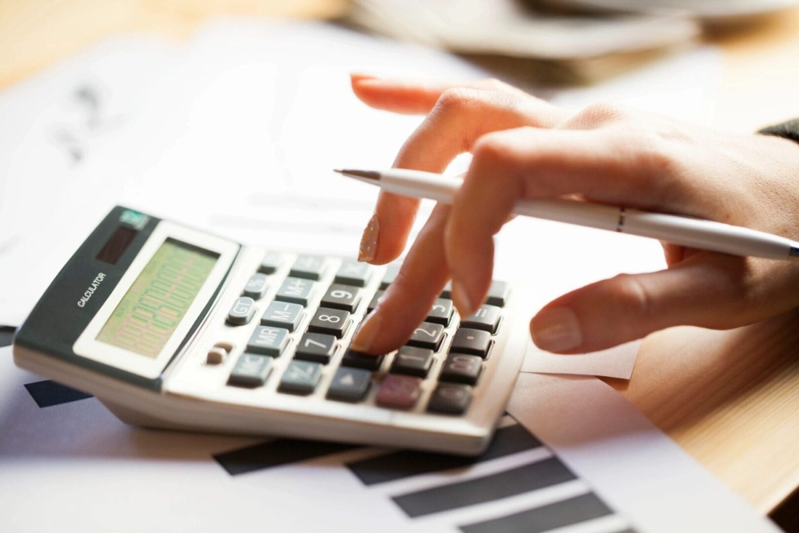 Close-up view of a girl hand using calculator